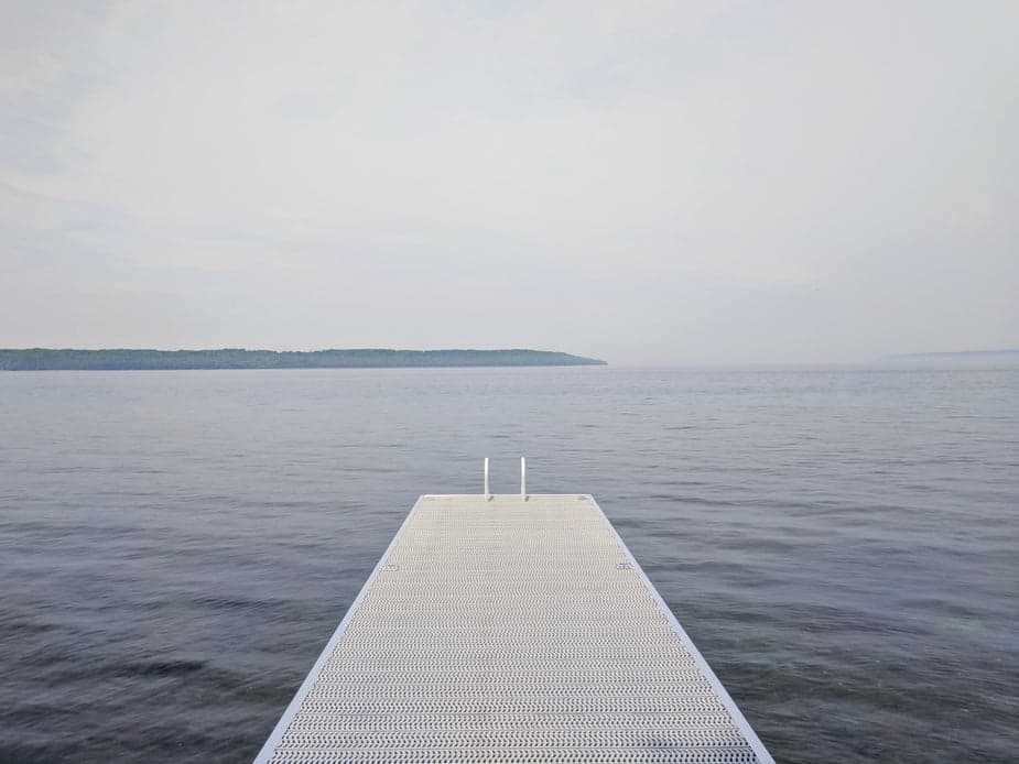 Wooden dock over still water — stillness between sessions